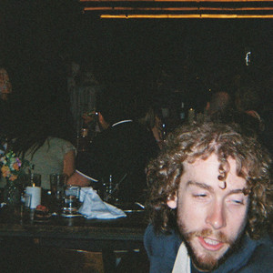 Cover art for the album 'spacecowboy' &mdash; a candid photograph taken in a dark, crowded bar.